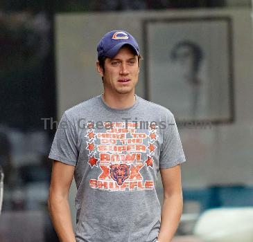 Vernon Kay arrives at the BBC Radio 1 studios to present his weekend show, wearing a Chicago Bears cap and t-shirt, white shorts and flip flops. 
London, England.