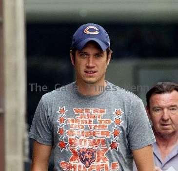 Vernon Kay arrives at the BBC Radio 1 studios to present his weekend show, wearing a Chicago Bears cap and t-shirt, white shorts and flip flops. 
London, England.