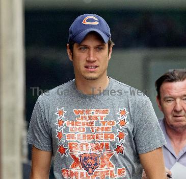 Vernon Kay arrives at the BBC Radio 1 studios to present his weekend show, wearing a Chicago Bears cap and t-shirt, white shorts and flip flops. 
London, England.