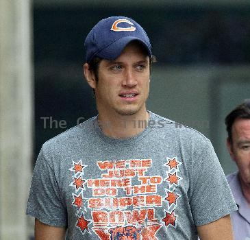 Vernon Kay arrives at the BBC Radio 1 studios to present his weekend show, wearing a Chicago Bears cap and t-shirt, white shorts and flip flops. 
London, England.