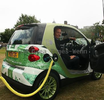 Motoring writer Quentin Willson
shows off Smart's new electric car at Tower Bridge
London, England.