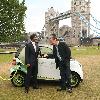 Motoring writer Quentin Willson
shows off Smart's new electric car at Tower Bridge
London, England.