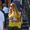 Elle Macpherson sporting a bright yellow top while out and about in London. London.