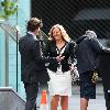 Paul Nichols and Jo Joyner filming a scene for BBC drama Candy Cabs. Jo is filming a kissing scene with Paul, the scene has to be re-shot with Jo stood on a wooden to make her tall enough. 
Manchester, England.