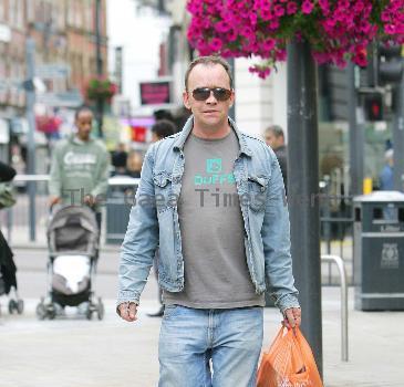 Todd Carty out and about in Leeds Town centre holding a grocery bag.
London, England.