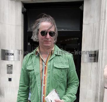 REM guitarist Peter Buck 
leaving the BBC Radio Two studios where he was promoting his new side project, Tired Pony
London, England.