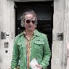 REM guitarist Peter Buck 
leaving the BBC Radio Two studios where he was promoting his new side project, Tired Pony
London, England.