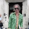 REM guitarist Peter Buck 
leaving the BBC Radio Two studios where he was promoting his new side project, Tired Pony
London, England.