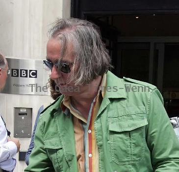 REM guitarist Peter Buck 
leaving the BBC Radio Two studios where he was promoting his new side project, Tired Pony
London, England.