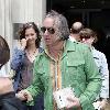 REM guitarist Peter Buck 
leaving the BBC Radio Two studios where he was promoting his new side project, Tired Pony
London, England.