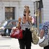 Emma Rigby cant resist letting down her long blonde hair, when she spots our photographer, as she strolls through central London, carrying two large handbags. London.