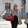 Emma Rigby cant resist letting down her long blonde hair, when she spots our photographer, as she strolls through central London, carrying two large handbags. London.