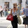 Emma Rigby cant resist letting down her long blonde hair, when she spots our photographer, as she strolls through central London, carrying two large handbags. London.