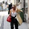 Emma Rigby cant resist letting down her long blonde hair, when she spots our photographer, as she strolls through central London, carrying two large handbags. London.