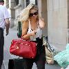 Emma Rigby cant resist letting down her long blonde hair, when she spots our photographer, as she strolls through central London, carrying two large handbags. London.