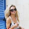 Emma Rigby cant resist letting down her long blonde hair, when she spots our photographer, as she strolls through central London, carrying two large handbags. London.