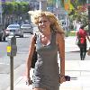 Pussycat Doll Ashley Roberts in a tight grey dress leaves the Ken Paves hair salon after attending the charity event,