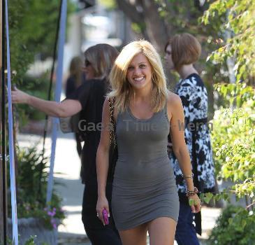 Pussycat Doll Ashley Roberts in a tight grey dress leaves the Ken Paves hair salon after attending the charity event,