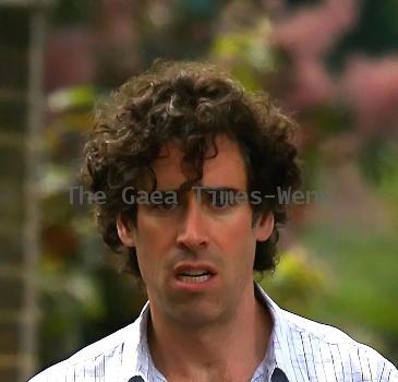 Comedy actor Stephen Mangan walking with a shopping bag in North London London.