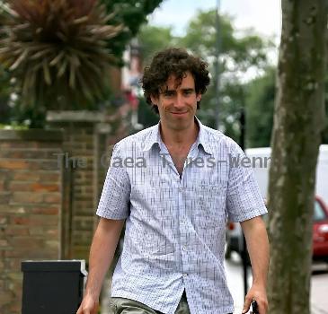 Comedy actor Stephen Mangan walking with a shopping bag in North London London.