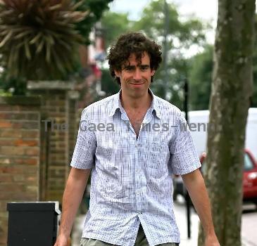 Comedy actor Stephen Mangan walking with a shopping bag in North London London.