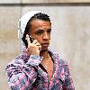 Aston Merrygold of JLS
shows off an Audi R8 sports car as he arranges to pay the parking fee over his mobile phone. 
London, England.