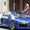 Aston Merrygold of JLS
shows off an Audi R8 sports car as he arranges to pay the parking fee over his mobile phone. 
London, England.