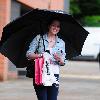 Helen Flanagan returns to the 'Coronation Street' set after shopping in the heavy rain.Manchester.