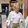 Zoe Wanamaker
appears unhappy as a photographer tries to take her picture while she walks through Soho carrying a cup of coffee. 
London, England.