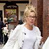 Zoe Wanamaker
appears unhappy as a photographer tries to take her picture while she walks through Soho carrying a cup of coffee. 
London, England.