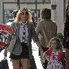 Geri Halliwell with Bluebell Madonna after lunch at a restaurant. Geri sporting a grey blazer, shirt and tie, shorts and boots, as she strolls about with her daughter in central London. London.