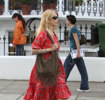 Claudia Schiffer 
looking fantastic in a summer dress, after dropping her children off at school. The supermodel has shifted the baby weight after delivering her third child in May.
London, England.