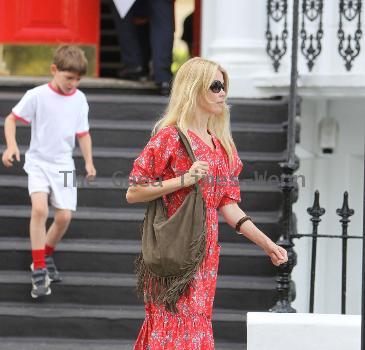 Claudia Schiffer 
looking fantastic in a summer dress, after dropping her children off at school. The supermodel has shifted the baby weight after delivering her third child in May.
London, England.