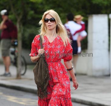 Claudia Schiffer 
looking fantastic in a summer dress, after dropping her children off at school. The supermodel has shifted the baby weight after delivering her third child in May.
London, England.