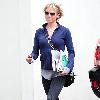 Renee Zellweger running errands in Santa Monica wearing zip-up fleece and sweats. Los Angeles.