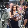 Kim Kardashian using a fan and drinking water while filming an interview for the entertainment television news programme 'Extra' at The Grove in Hollywood
Los Angeles, California.