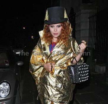 Paloma Faith wearing a Top hat, gold cape and ruby shoes leaves La Caprice after dining with Jools Holland and friends. London.