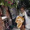 Kelly Rowland walking to a recording studio in central London, carrying a fur coat. London.