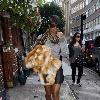 Kelly Rowland walking to a recording studio in central London, carrying a fur coat. London.