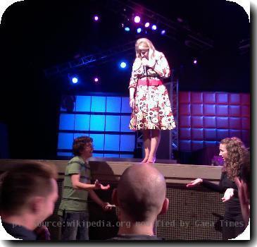 Lisa Lampanelli on stage making fun of an audience member.