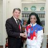 C50027-6, President Reagan greeting Florence Griffith Joyner of the U.S. Olympic team in the oval office. 10/24/88.