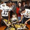 wSergio Kindle (left) a linebacker from Dallas and Chris Caflisch, a wide receiver from San Antonio sign posters and miniature footballs for children from the Warm Springs Rehabilitation Center in San Antonio. Both players