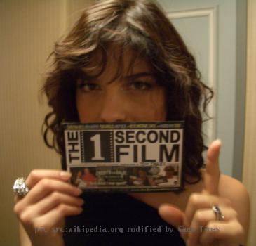 Selma Blair holding a postcard for The 1 Second Film