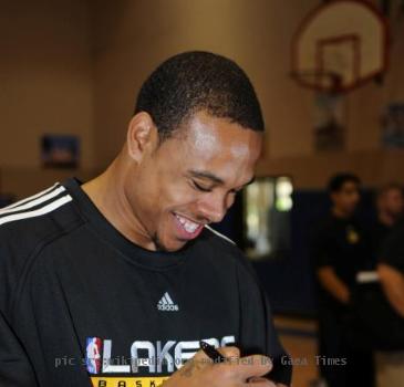 SAN DIEGO (Oct. 23, 2009) - NBA star Shannon Brown of the Los Angeles Lakers autographs a basketball for service members in the Naval Medical Center San Diego gym. During a surprise visit, players and coaches signed autog