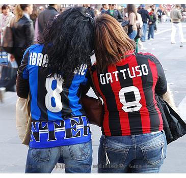 Fans demonstrating friendship in the Milan Derby between football rivals FC Inter and AC Milan.