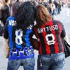 Fans demonstrating friendship in the Milan Derby between football rivals FC Inter and AC Milan.