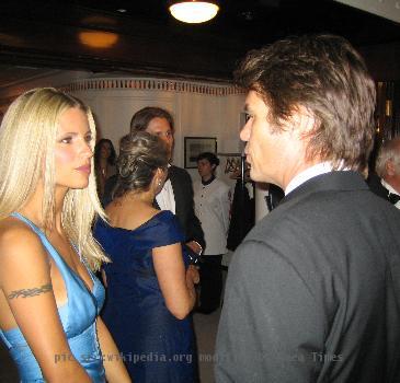 Michelle Hunziker talking to Harry Hamlin on board the Royal Yacht Britannia on the occasion of the bir
