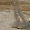 Marines with 2nd Combat Engineer Battalion launch a line charge from an Assault Breacher Vehicle here for the first time in the fleet, Nov. 23. The line charge, a long string of C4 explosives attached to a rocket, is used