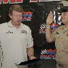 051021-N-3659B-001 Millington, Tenn. (Oct. 21, 2005) - Chief Aviation Ordnanceman Mark Stites takes the Oath of Enlistment read by professional NASCAR driver Bill Elliot at Memphis Motor Sports Park before the Sa