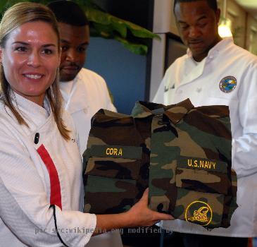 MAYPORT, Fla. (Nov. 13, 2007) Chef Cat Cora, from Food Networks Iron Chef America, proudly displays a set of BDUs with her name, which she received from Naval Mobile Construction Battalion Gulfport, Mississippi, team m